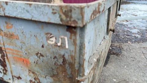 Rusty dumpster located on busy city street, vividly showcasing the inevitable Stock Footage 316469135