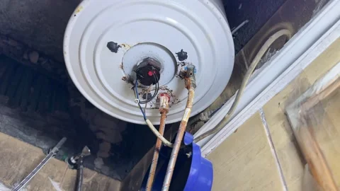 Rusty Electric Water Heater Base with Corroded Pipes and Wiring Stock Footage 331634776