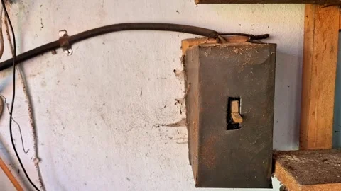 Rusty Electrical Junction Box Mounted on Weathered Wall in Abandoned Building 스톡 동영상 348629971