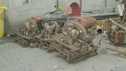 Rusty engine assemblies in a salvage yard Video stock 347035343