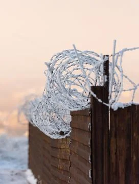 Rusty fence with barbed wire Stock Photos