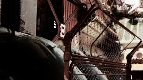 Rusty Fence Frames Ancient Industrial Pipes in an Abandoned Factory Setting Stock Footage 344824896