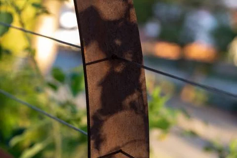 Rusty Fence Post with Wire Cables and Shadows Stockfoto's