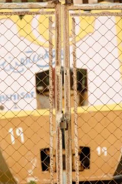 Rusty fence secured with a padlock Stock Photos