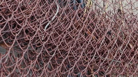 Rusty fencing mesh stands twisted on the street Stock Footage 306159306