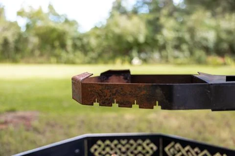 Rusty fire pit insert with interlocking notches and bent tabs Stock Photos