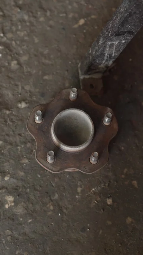 A rusty five-stud car wheel hub lying on ground. Stock Footage 342259707