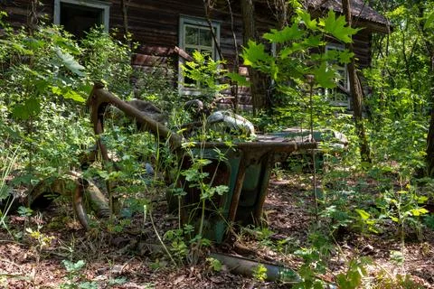 A rusty frame from a motorcycle against the background of an abandoned hous.. Stock Photos