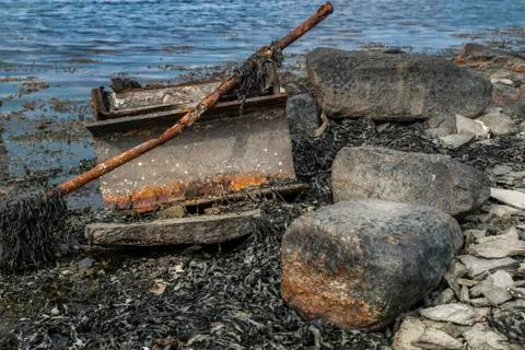 Rusty garbage by the ocean Stock Photos