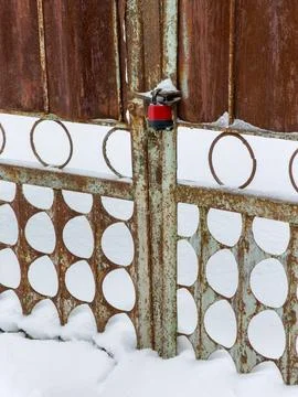 A rusty gate with a red lock on it Stock Photos