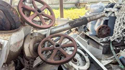Rusty gears and mechanical components scattered in industrial environment Stock Photos