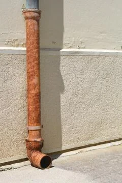 Rusty Gutter Downpipe on Plaster Wall Stock Photos