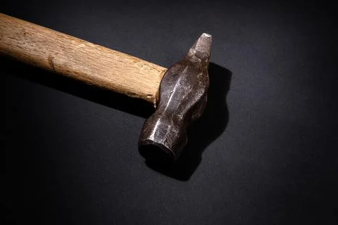 Rusty hammer on a black background. Stock Photos
