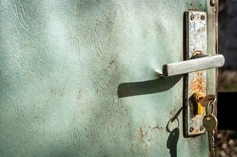 Rusty handle of an old worn open door Stock Photos