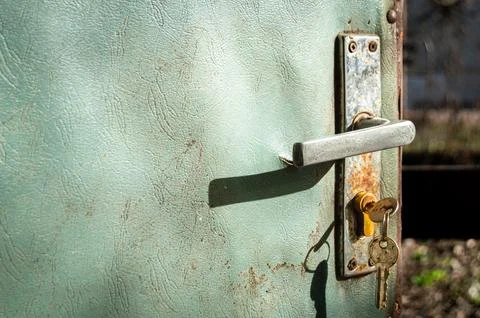Rusty handle of an old worn open door Stock Photos