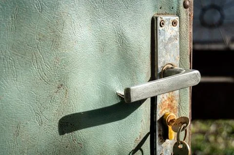 Rusty handle of an old worn open door Stock Photos