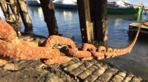 Rusty harbor chain swings in the wind. Scotland Stock Footage 65263719