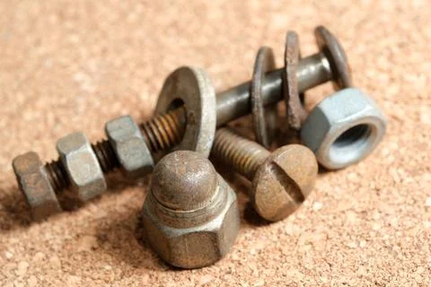 Rusty hardware arranged on a textured surface for display Stock Photos