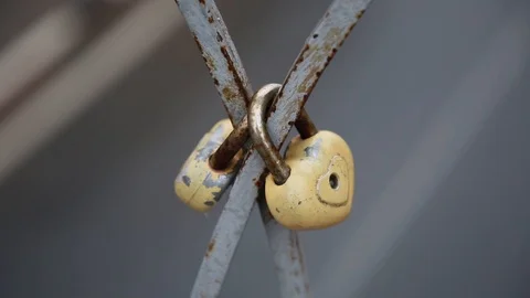 Rusty heart-shaped lock on a bridge Stock Footage 119983464