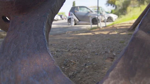 Rusty Heavy Metal Object Detail with Bolt in 6K Slow Motion in Sunny Car Park 動画素材 334437109