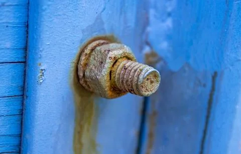 Rusty Hex Nut and Bolt Threaded on Blue Painted Surface Stock Photos