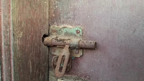 Rusty hinge lock attached to a wooden door	 Stock Footage 326296456