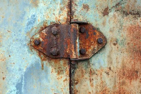Rusty hinge on old rusted iron door, close-up Stock Photos