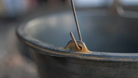 A rusty hook on the handle of a bucket Stock Photos