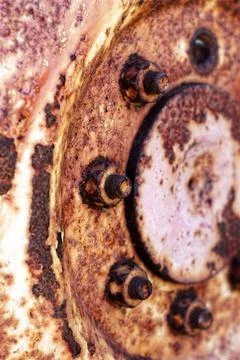 Rusty hub of tractor wheel close up background - vertical Stock Photos