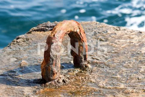 Rusty iron attachment in dock Stock Photos