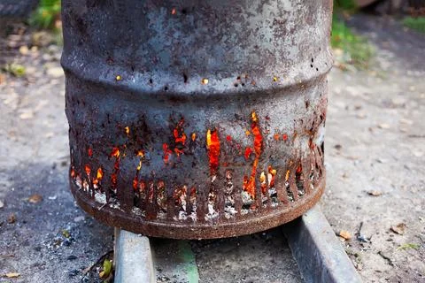 Rusty iron barrel for burning garbage on a farm Stock Photos