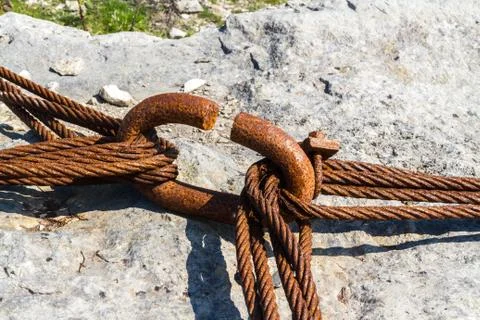 Rusty iron cables linked around hoop. Stock Photos