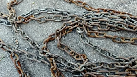 Rusty Iron Chains Tangled on Concrete Background Stock Footage 333121608
