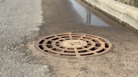 A rusty iron hatch with a pattern above an observation well is located on auto Stock Footage 300052972