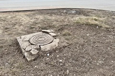 A rusty iron hatch with a pattern and a large gap at the top is mounted in a Stock Photos
