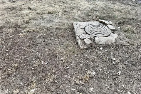 A rusty iron hatch with a pattern and a large gap at the top is mounted in a Stock Photos