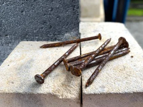 Rusty iron nails were placed on the wall Stock Photos