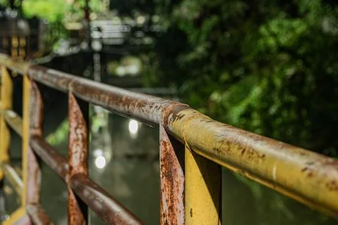 Rusty iron pipe barrier at night inside dark background Фото