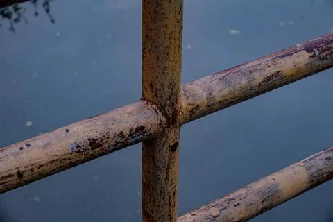 Rusty iron pipe cross joint detail at twilight close up Фото