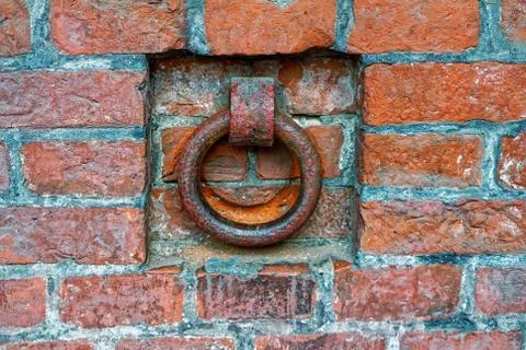 A rusty iron ring in an old brick wall Stock Photos