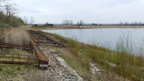Rusty iron structures on the shore of the lake. 2017, Chernobyl, Ukraine Stock Footage 75235421