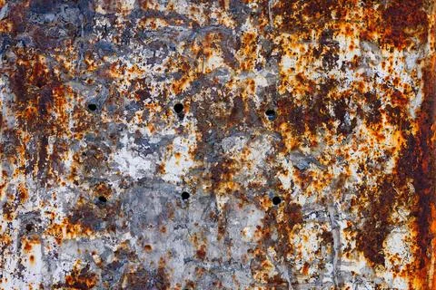 Rusty iron wall with thick layer of eroded and peeled off old paint and scum Stock Photos