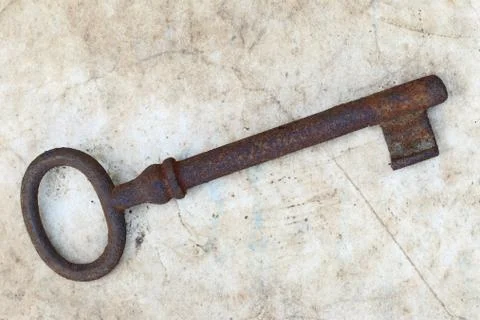 Rusty key on old parchment 写真素材