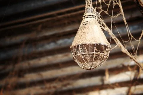 Rusty lamp hanging from ceiling with spiderwebs Stock Photos