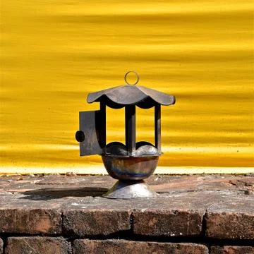 Rusty lantern on a brick plinth. Stock Photos