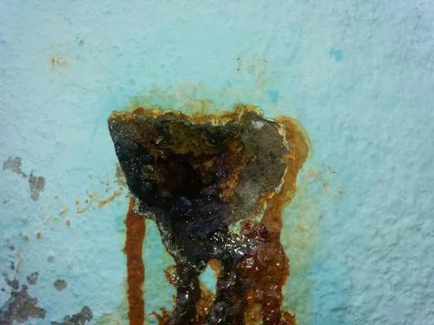 Rusty Leak in Wall Reveals Damage and Corrosion Over Time in an Indoor Settin Stock Photos