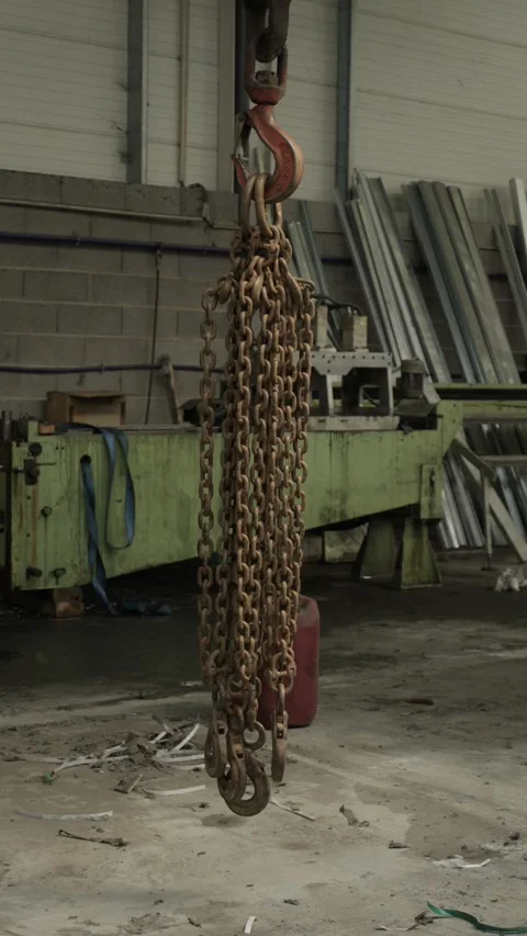 Rusty Lifting Chain Sling With Hooks Hanging From Crane Hook In Metal Workshop Stock Footage 337913388