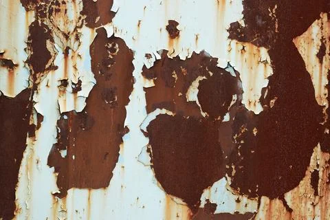 Rusty light brown peeling paint on a metal plate Stock Photos