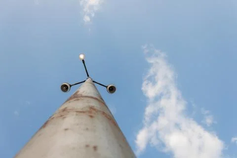 Rusty light pole with single active light 스톡 사진