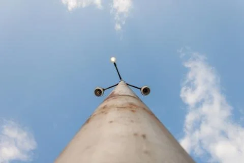 Rusty light pole with single active light, centered Stock Photos